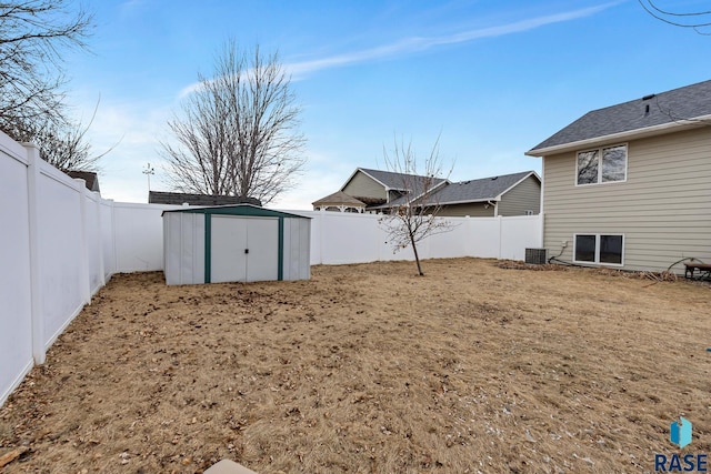 view of yard with central AC and a shed