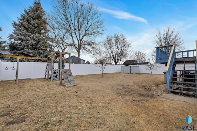 view of yard featuring a playground and a storage unit