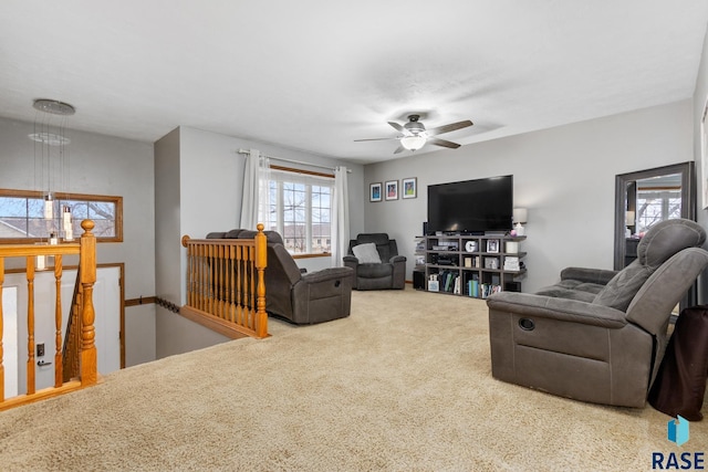 carpeted living room featuring ceiling fan