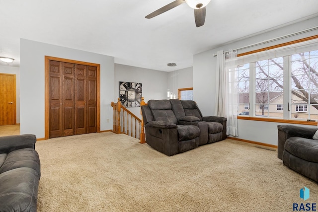 living room featuring ceiling fan and carpet