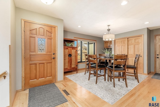 dining space featuring light wood-type flooring