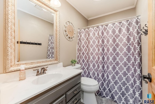 bathroom with crown molding, vanity, and toilet