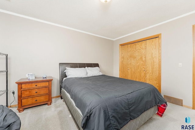 bedroom with light carpet, ornamental molding, and a closet