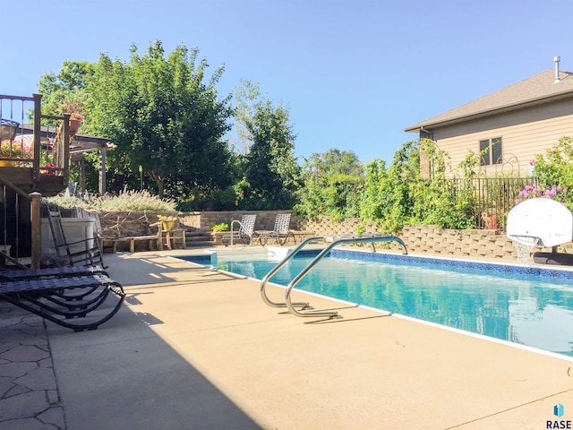 view of swimming pool with a patio