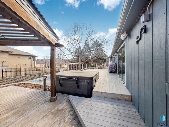 wooden terrace featuring a hot tub