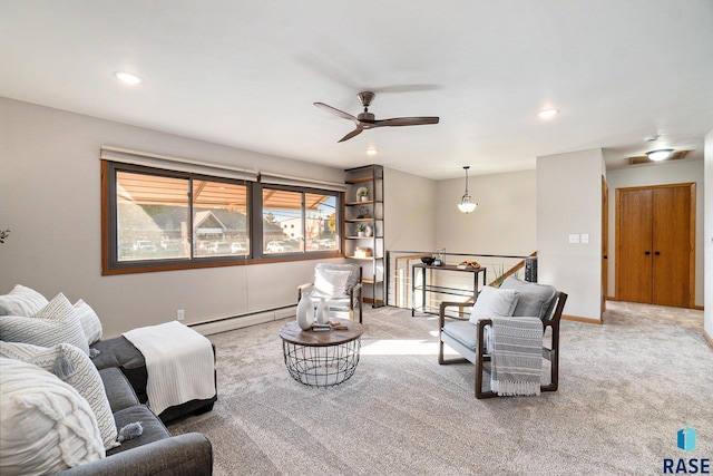 carpeted living room with ceiling fan and a baseboard radiator