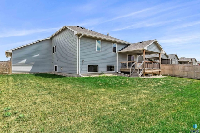 back of house featuring a wooden deck and a lawn