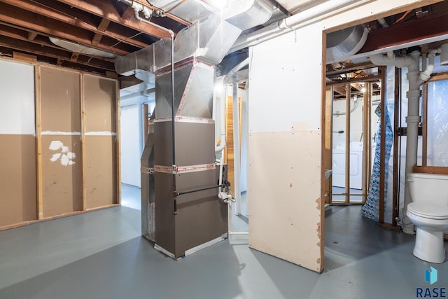 basement featuring washer / clothes dryer and heating unit