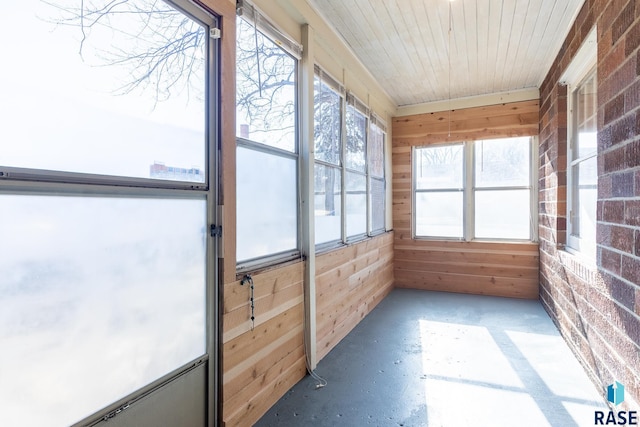 unfurnished sunroom with wooden ceiling