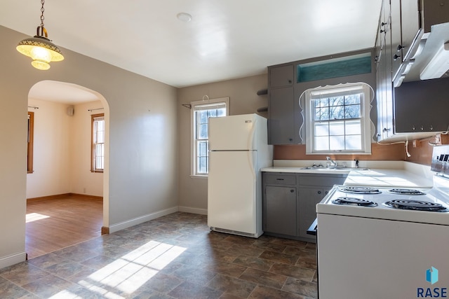 kitchen with white appliances, gray cabinets, sink, and hanging light fixtures