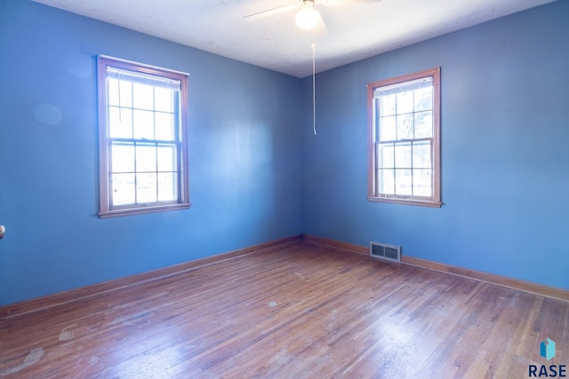 empty room featuring ceiling fan and light hardwood / wood-style flooring