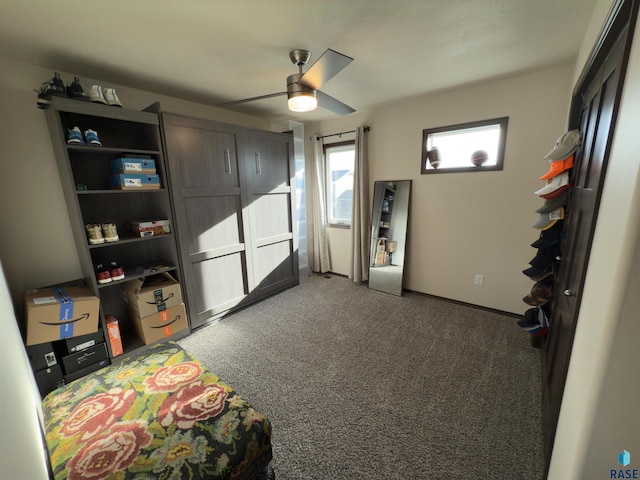 recreation room with dark carpet and ceiling fan