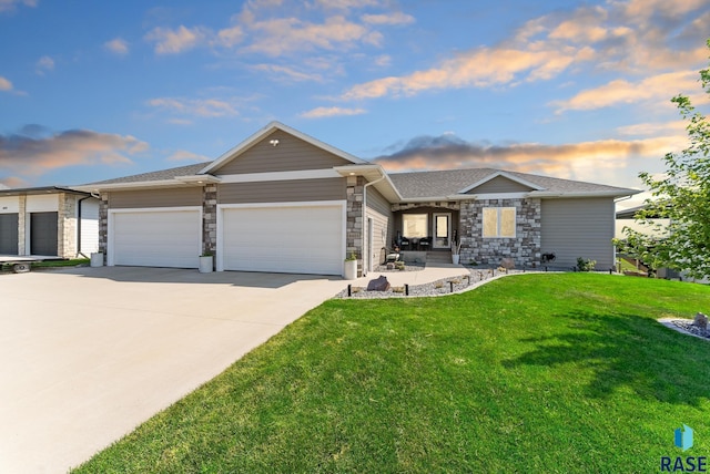 view of front of home with a garage and a lawn