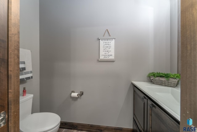 bathroom featuring vanity and toilet