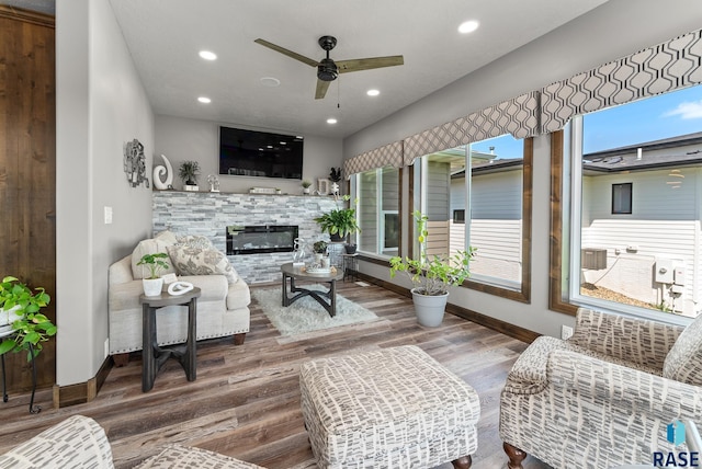 living room with ceiling fan, a fireplace, and hardwood / wood-style floors