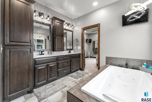 bathroom with vanity and tiled tub