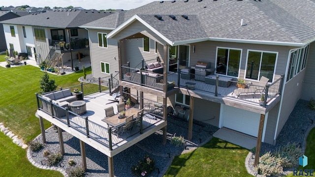 rear view of house with an outdoor living space, a lawn, and a patio