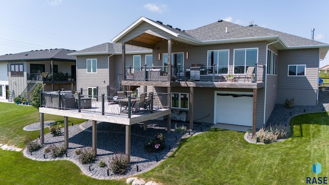 rear view of property featuring a yard, a garage, and a deck