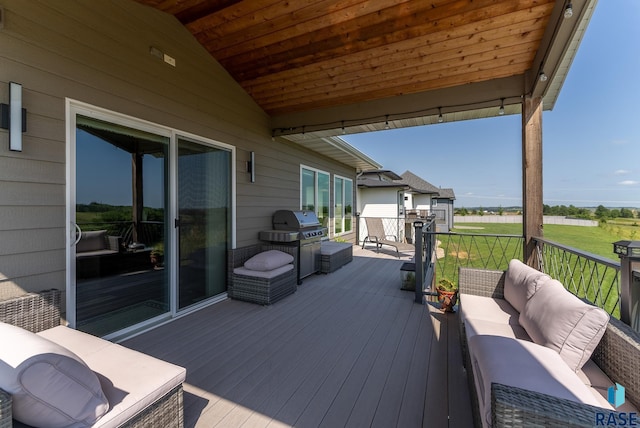 deck with a grill and an outdoor hangout area