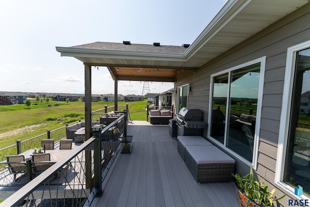 wooden deck with area for grilling and an outdoor hangout area