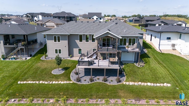 rear view of property with a wooden deck and a lawn