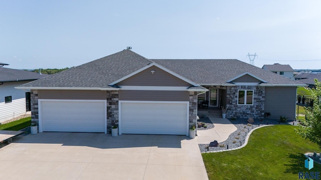 ranch-style house featuring a garage and a front yard