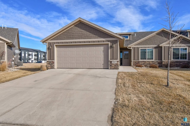 craftsman house with a garage and a front lawn