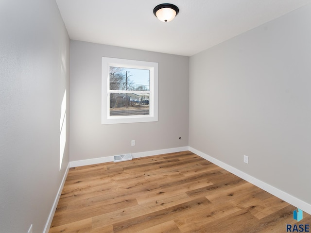 unfurnished room featuring wood-type flooring