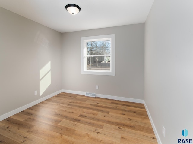 spare room featuring hardwood / wood-style flooring