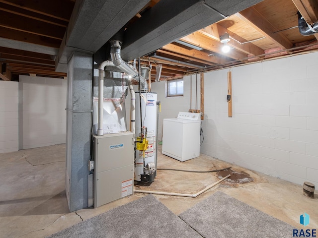 basement with heating unit, washer / clothes dryer, and water heater