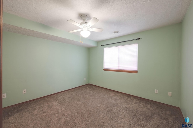 unfurnished room with ceiling fan, carpet, and a textured ceiling