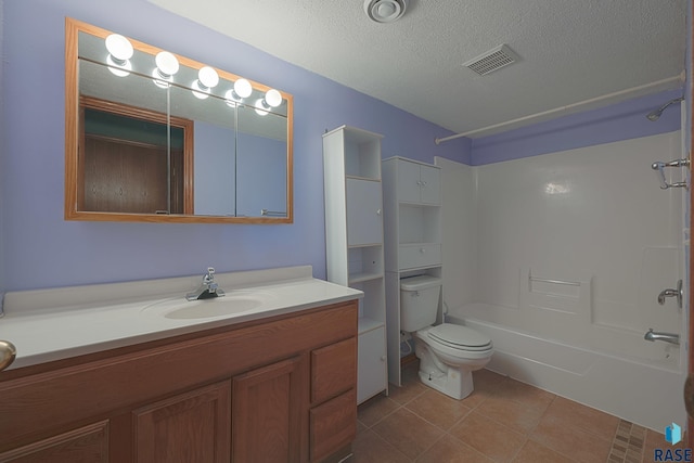 full bathroom with shower / washtub combination, tile patterned flooring, vanity, toilet, and a textured ceiling