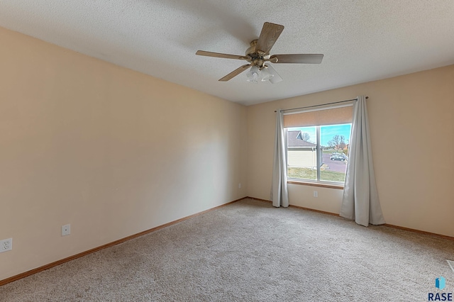 carpeted spare room with ceiling fan and a textured ceiling