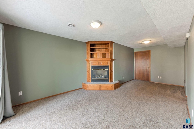 unfurnished living room featuring carpet and a textured ceiling