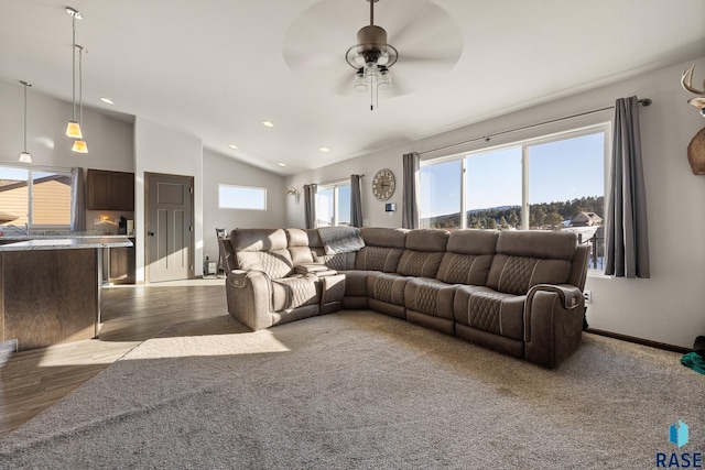 living room featuring ceiling fan, plenty of natural light, and vaulted ceiling