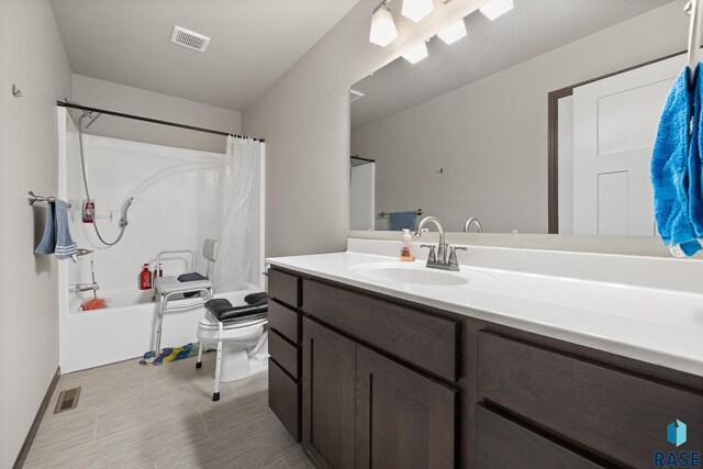 full bathroom with vanity, toilet, and shower / bath combo with shower curtain