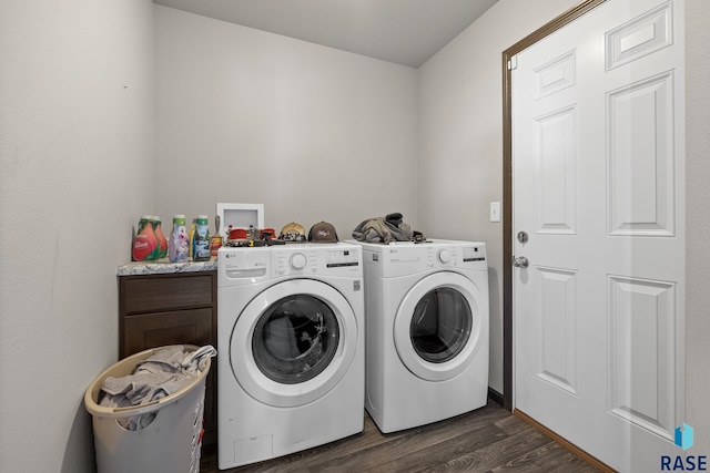 laundry area with cabinets, dark wood-type flooring, and washing machine and clothes dryer