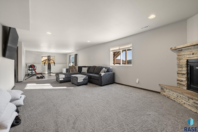 carpeted living room featuring a fireplace