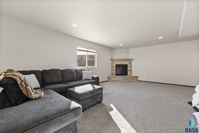 carpeted living room featuring a stone fireplace