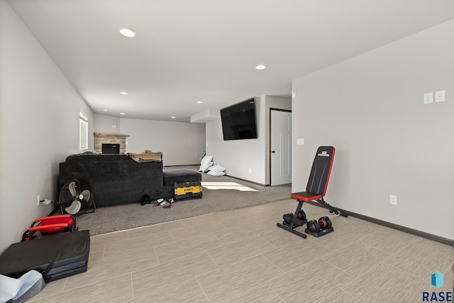 exercise area featuring a stone fireplace