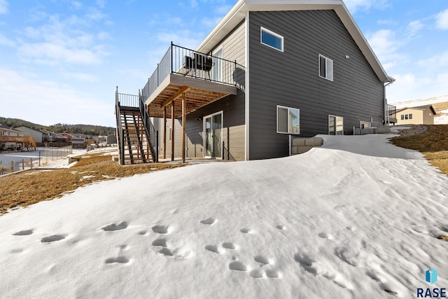 view of snow covered exterior featuring a deck