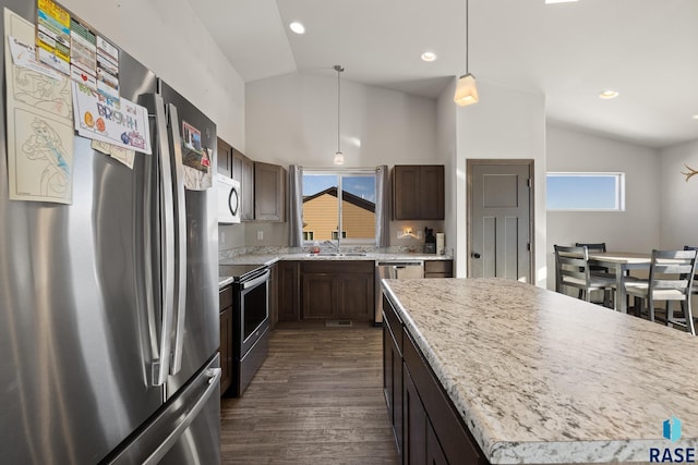 kitchen with a kitchen island, dark hardwood / wood-style floors, hanging light fixtures, stainless steel appliances, and dark brown cabinets