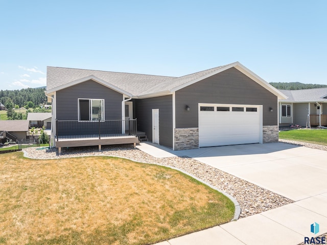 ranch-style home featuring a garage and a front yard