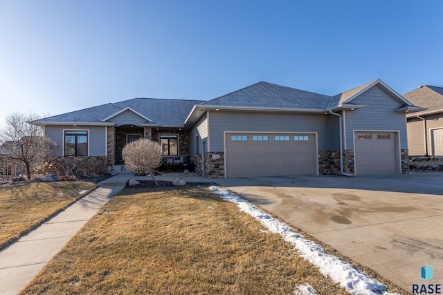 view of front of property with a garage and a front lawn