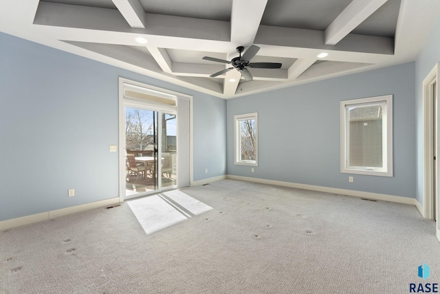 empty room featuring ceiling fan, light colored carpet, coffered ceiling, and beamed ceiling