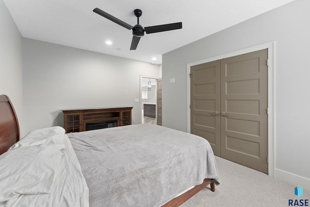 bedroom with ceiling fan, carpet flooring, and a closet