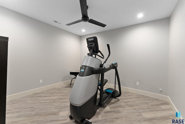 workout room featuring ceiling fan and light wood-type flooring