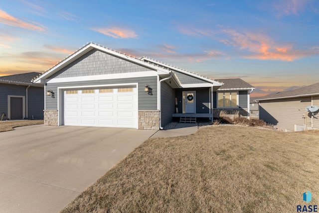 view of front of home featuring a garage and a lawn