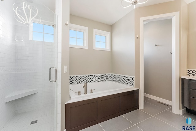 bathroom featuring tile patterned flooring, vanity, and separate shower and tub