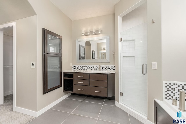 bathroom featuring vanity, decorative backsplash, tile patterned floors, and shower with separate bathtub